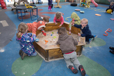 Children playing and running in the nursery playground